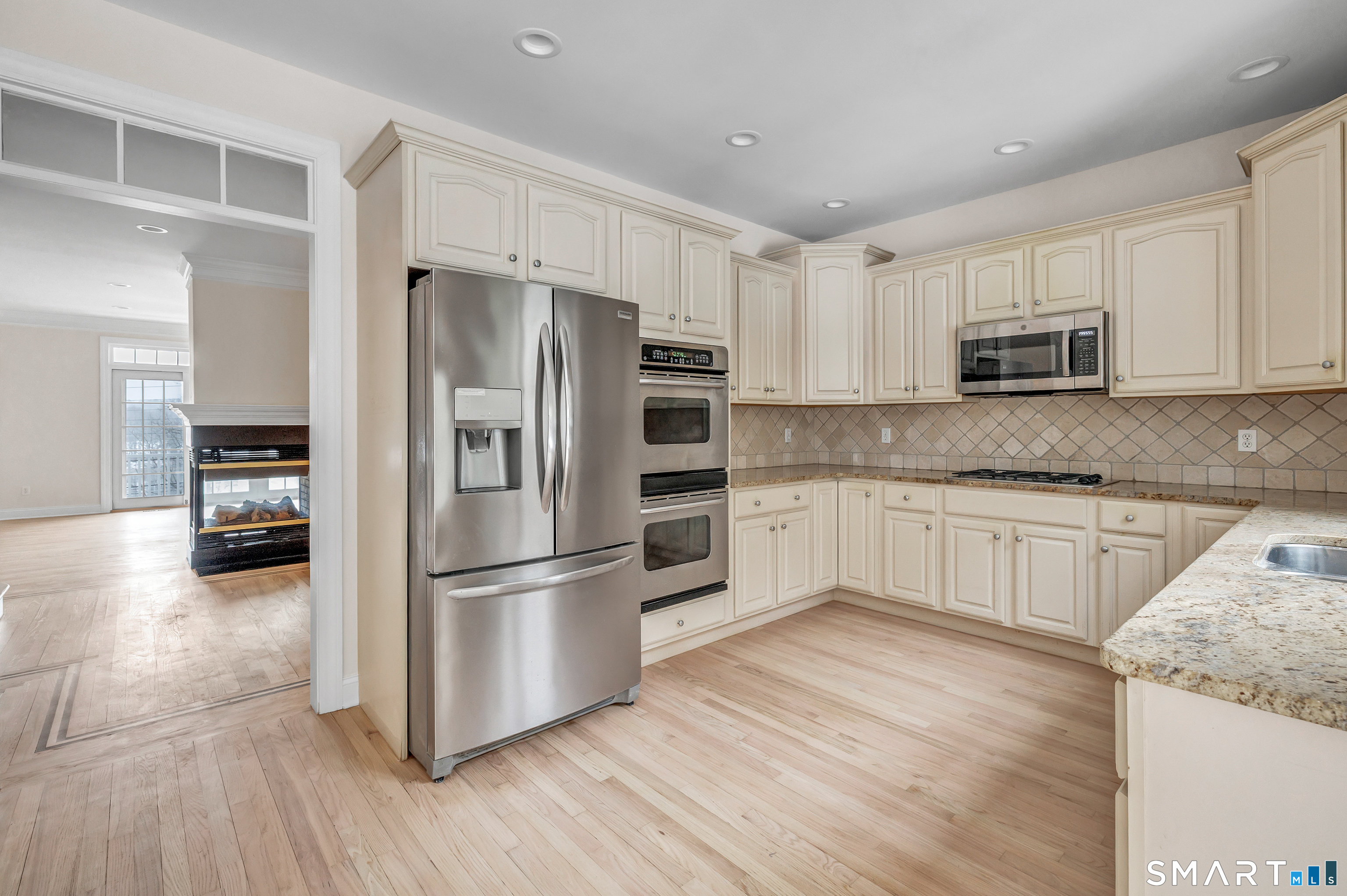 665 River Road, Unit 2 Shelton, CT 06484 - Photo 11 of 33 a kitchen with granite countertop a refrigerator and a stove top oven