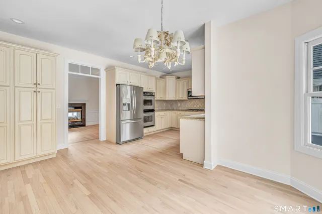 a view of a kitchen with a refrigerator a microwave and a sink