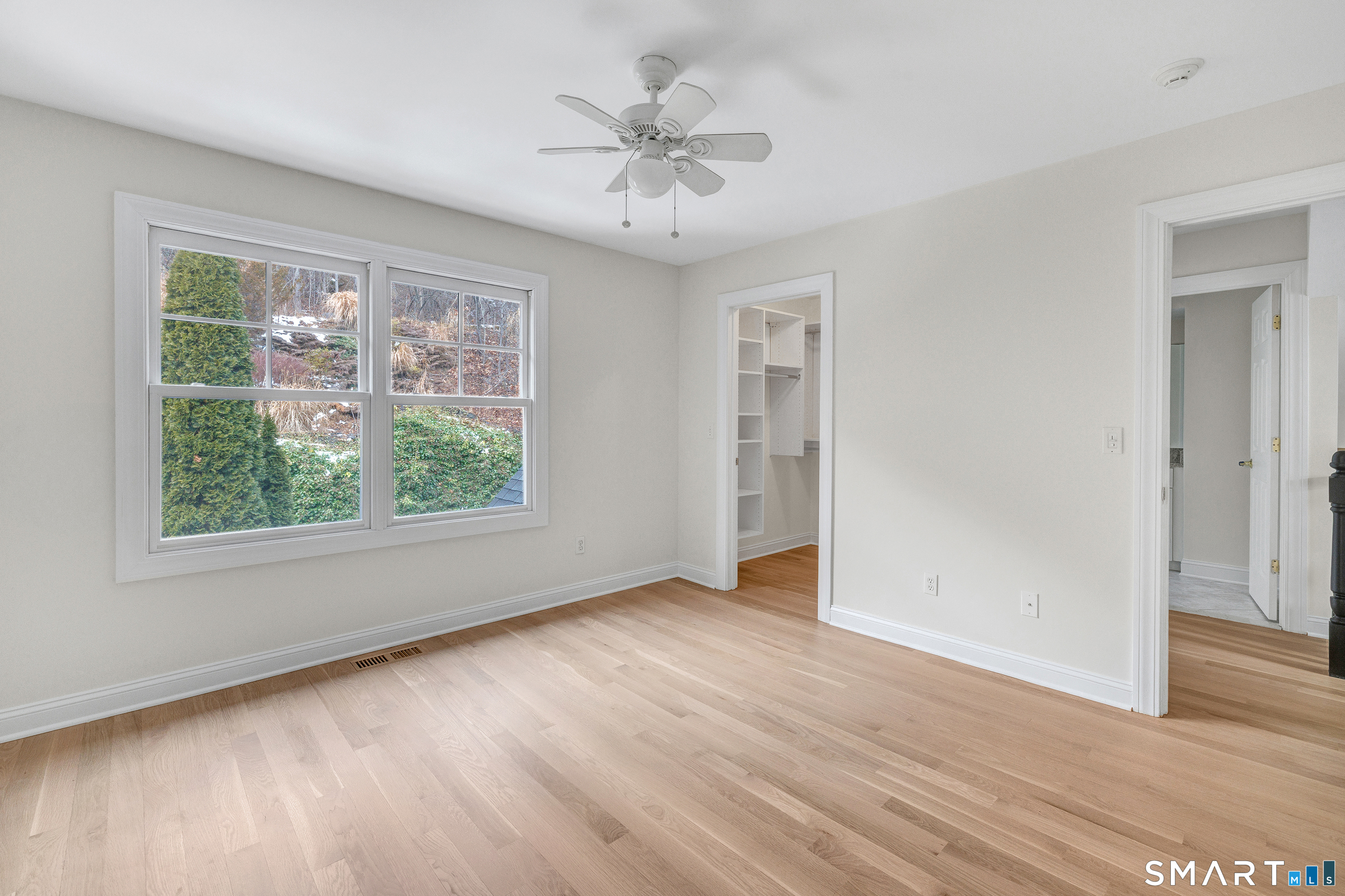 665 River Road, Unit 2 Shelton, CT 06484 - Photo 17 of 33 an empty room with wooden floor and windows