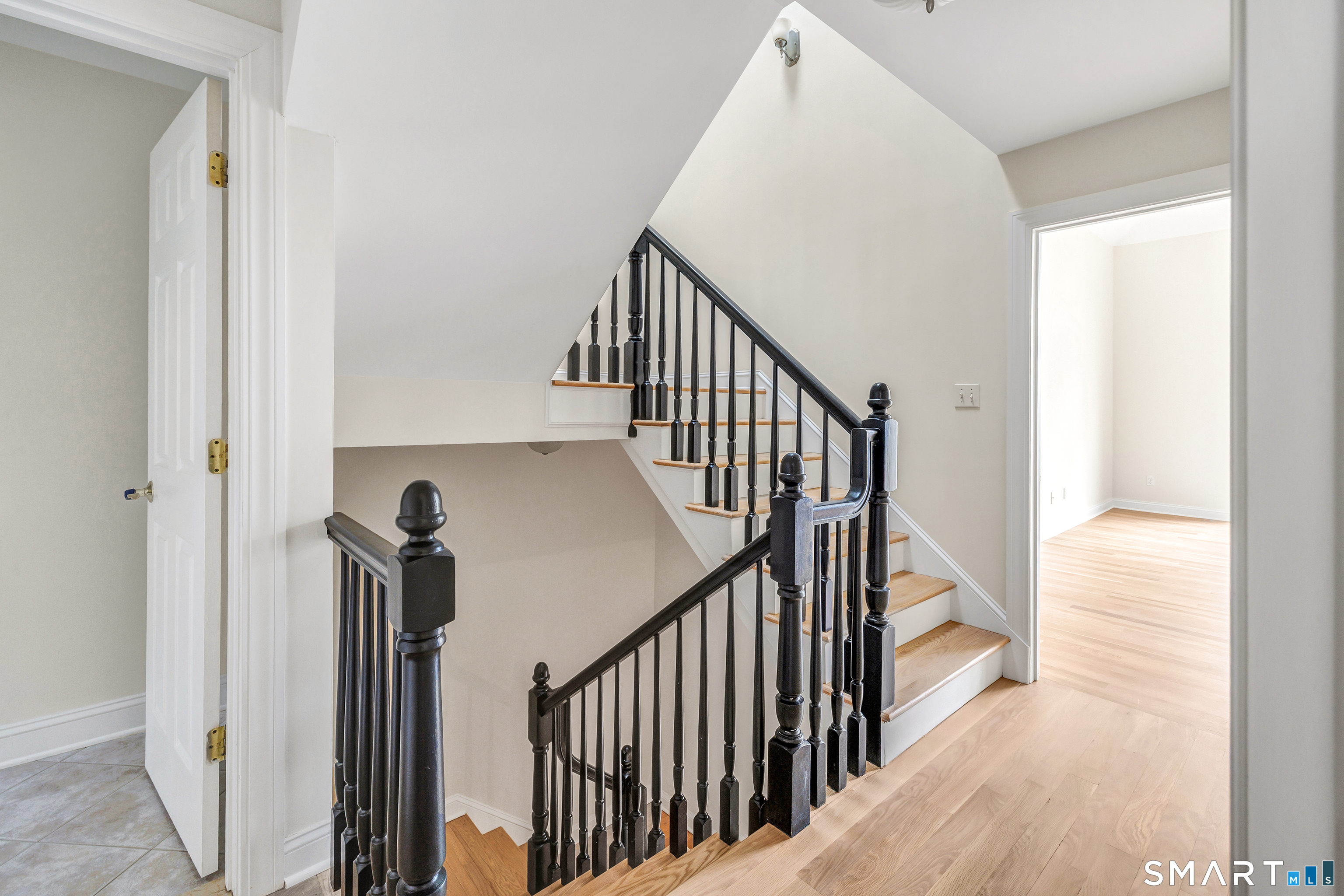 665 River Road, Unit 2 Shelton, CT 06484 - Photo 18 of 33 a view of a hallway with wooden floor and staircase