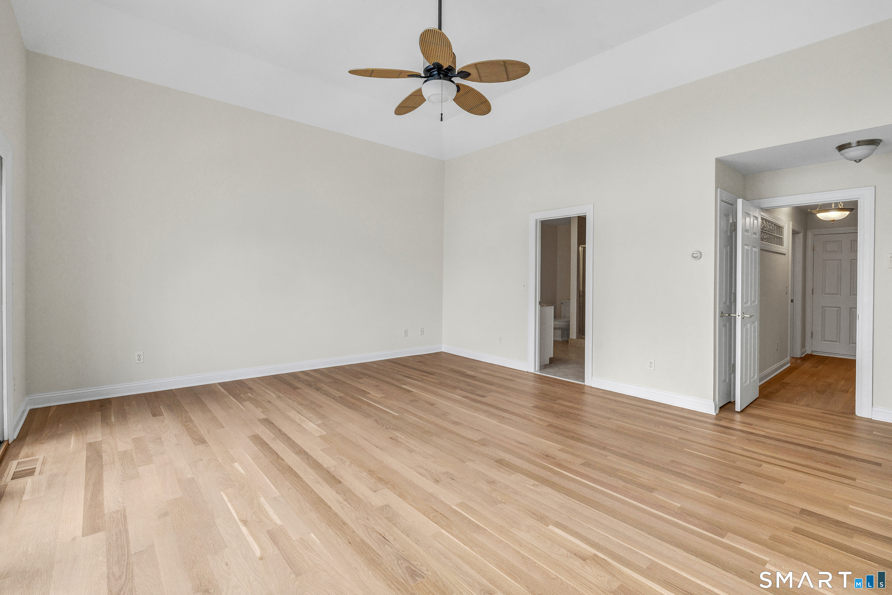 665 River Road, Unit 2 Shelton, CT 06484 - Photo 22 of 33 a view of empty room with wooden floor and fan