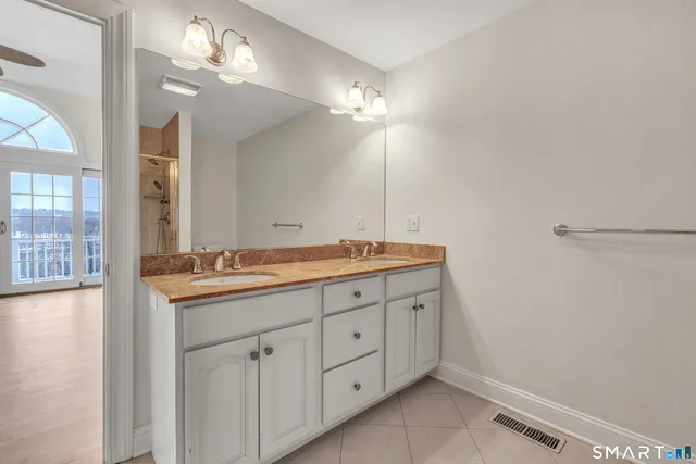 a bathroom with a double vanity sink and a mirror