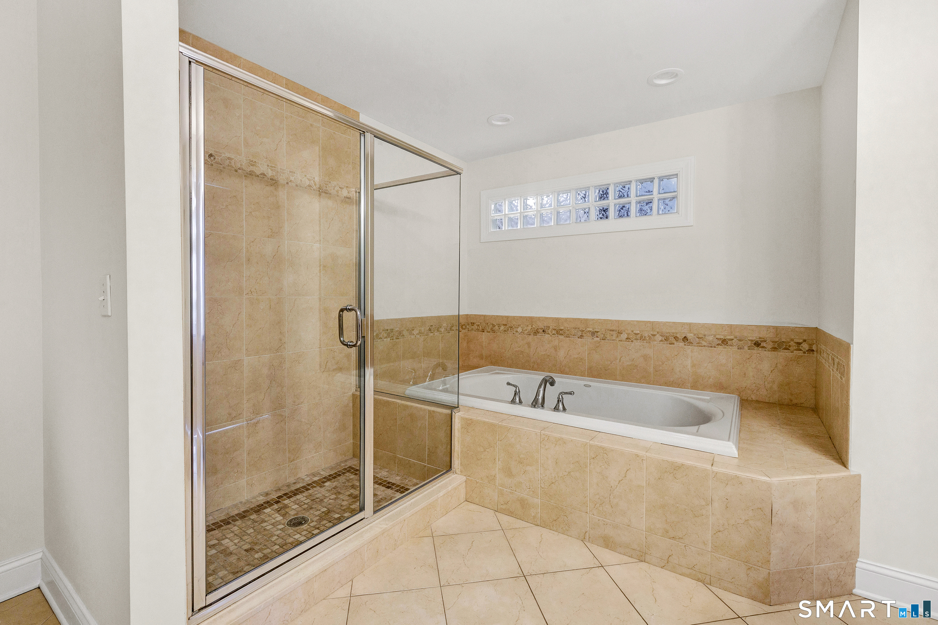 665 River Road, Unit 2 Shelton, CT 06484 - Photo 24 of 33 a bathroom with a bathtub and shower