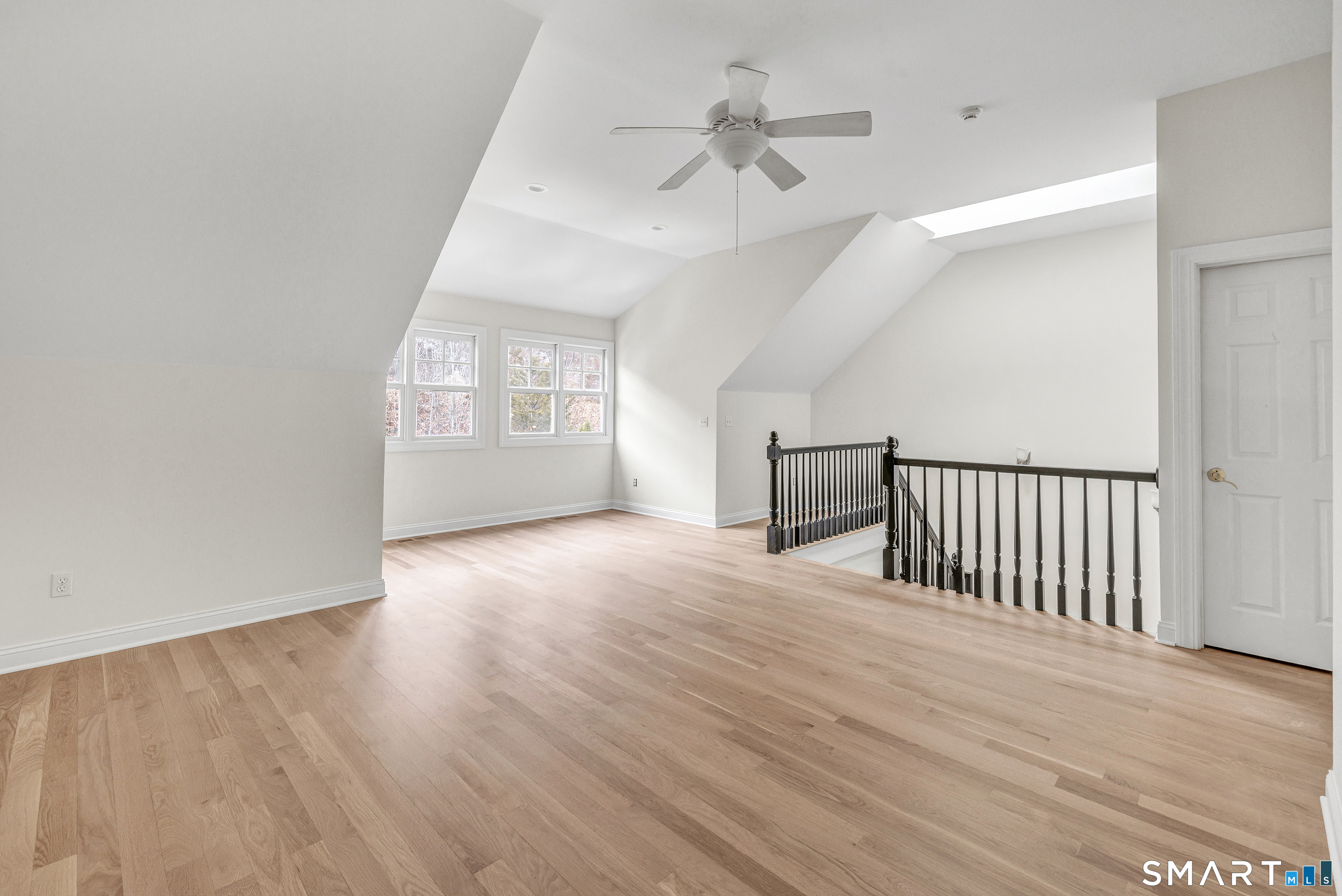 665 River Road, Unit 2 Shelton, CT 06484 - Photo 27 of 33 an empty room with wooden floor chandelier and windows