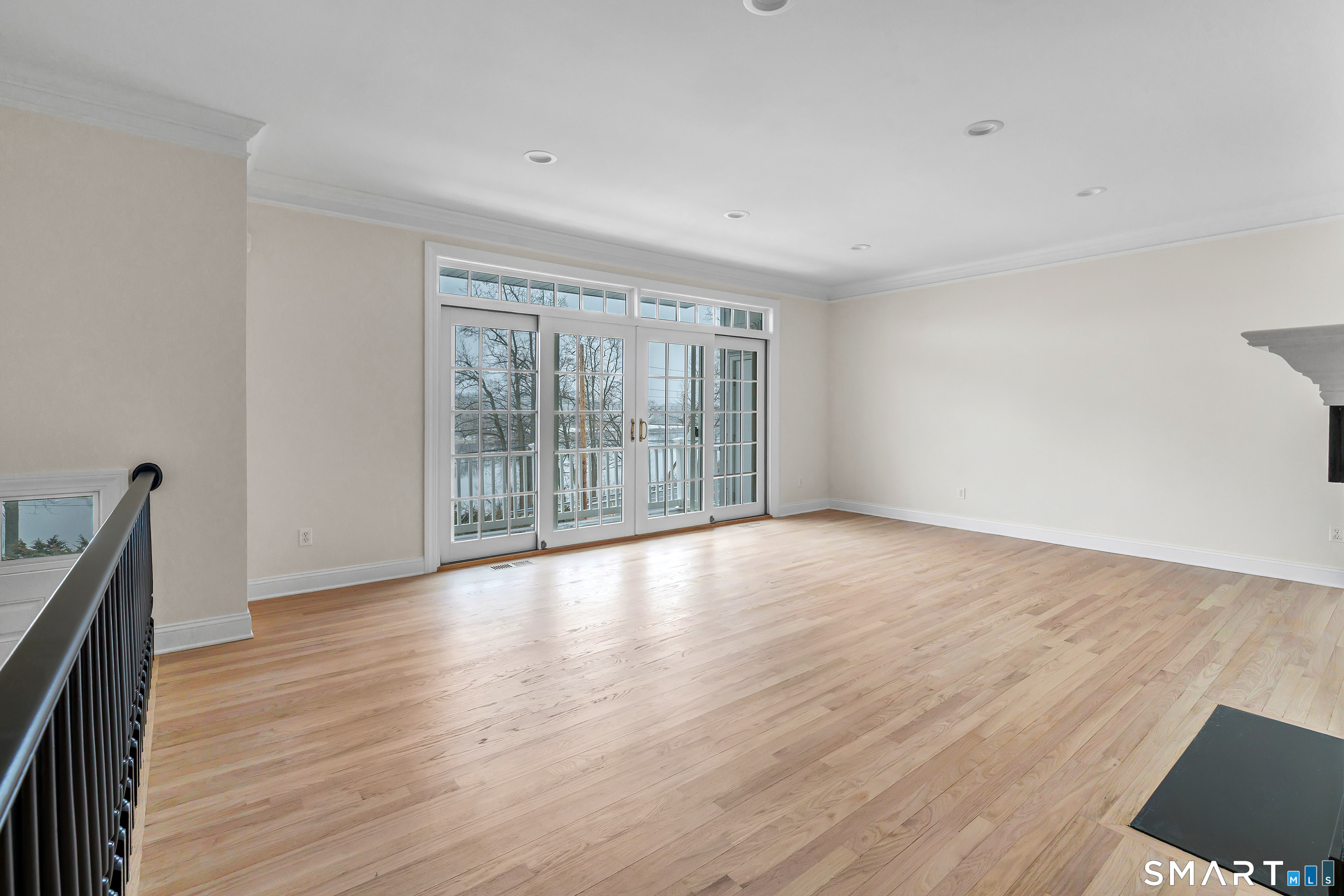 665 River Road, Unit 2 Shelton, CT 06484 - Photo 4 of 33 a view of an empty room with wooden floor and a window