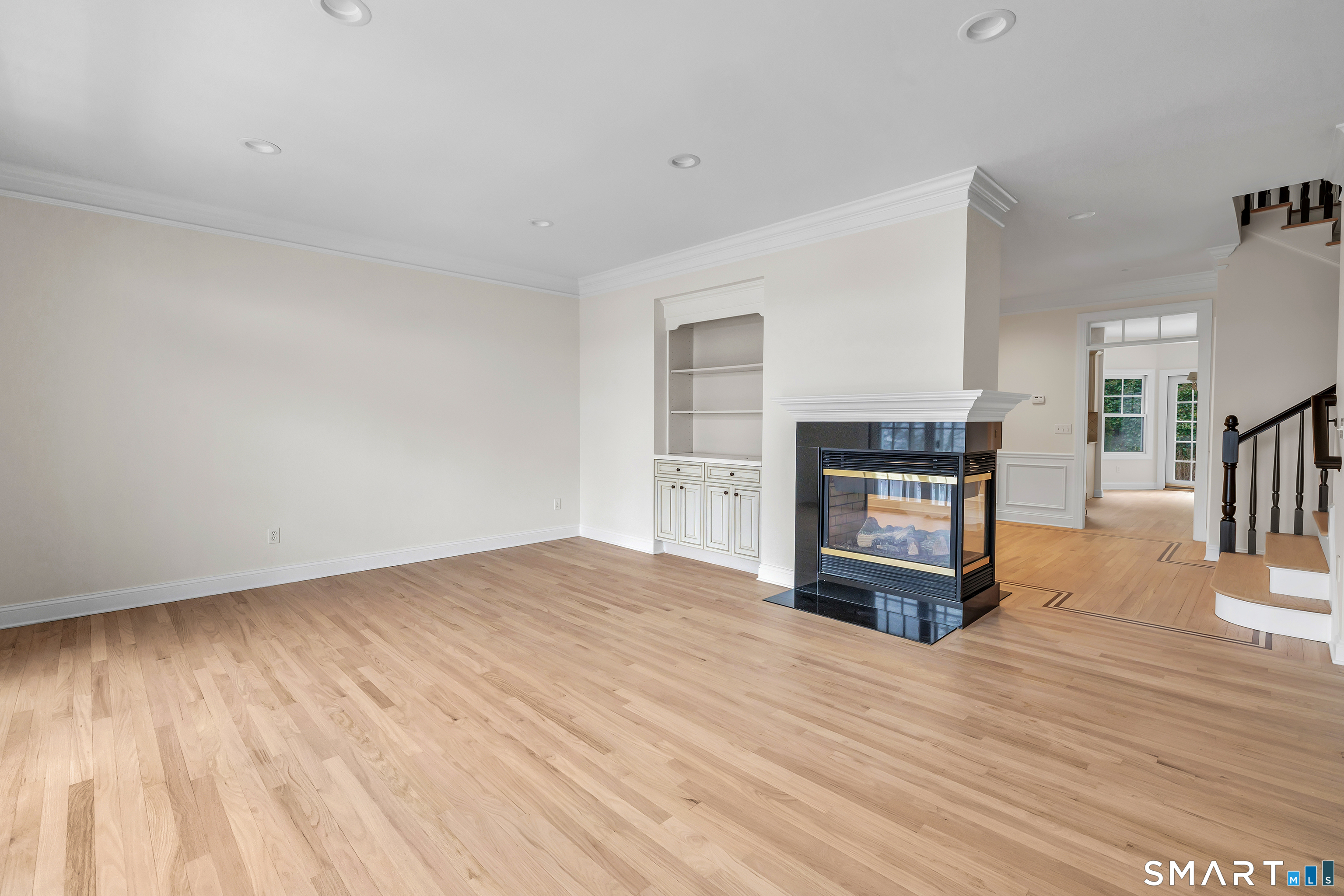 665 River Road, Unit 2 Shelton, CT 06484 - Photo 5 of 33 a view of empty room with wooden floor and fireplace