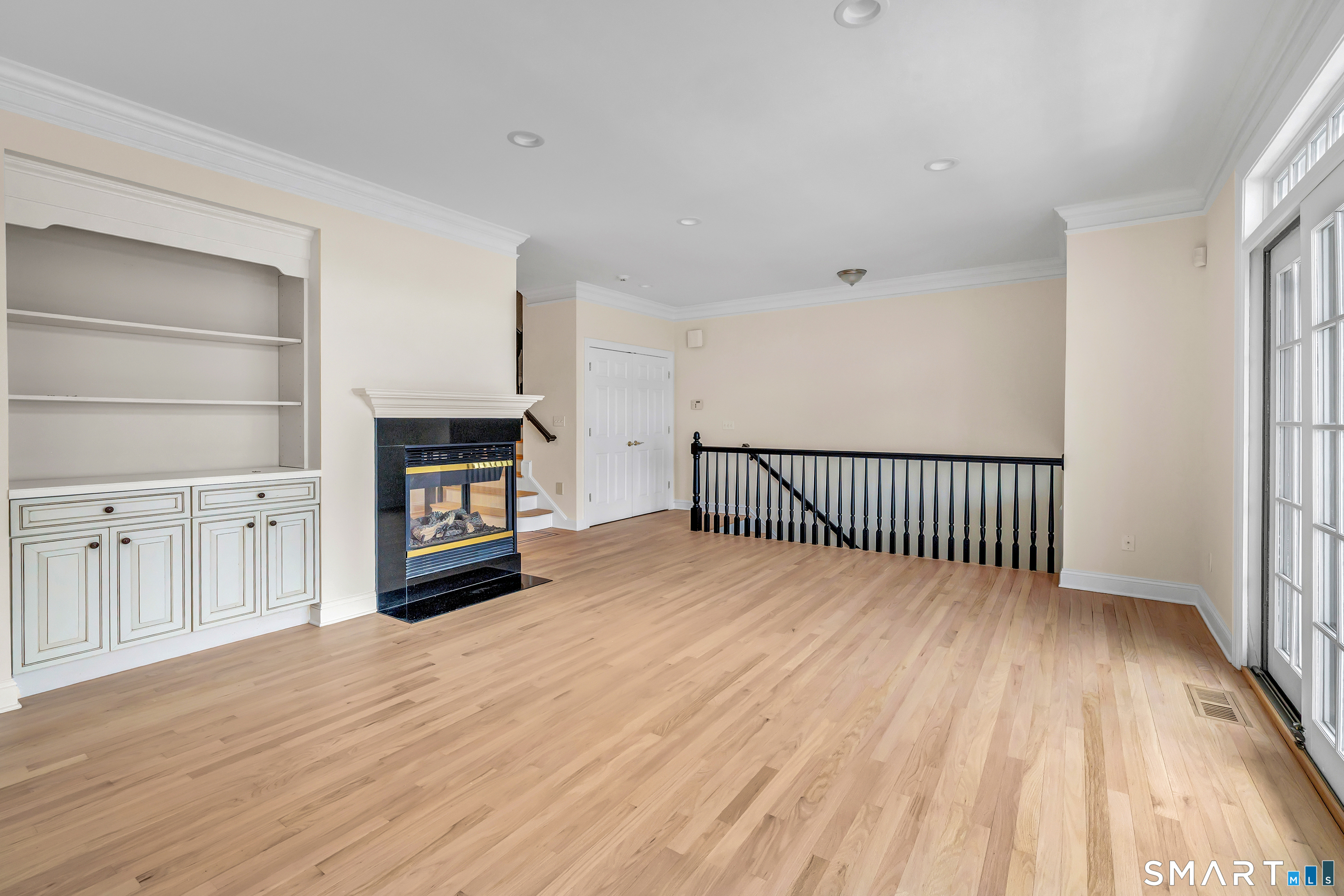 665 River Road, Unit 2 Shelton, CT 06484 - Photo 7 of 33 a view of a hallway with wooden floor and a fireplace