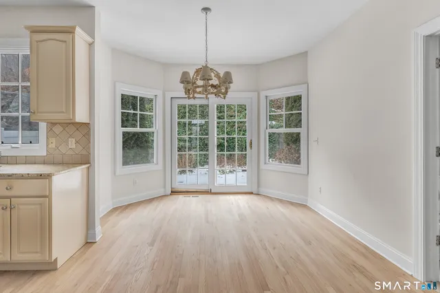 a view of wooden floor and windows in a room