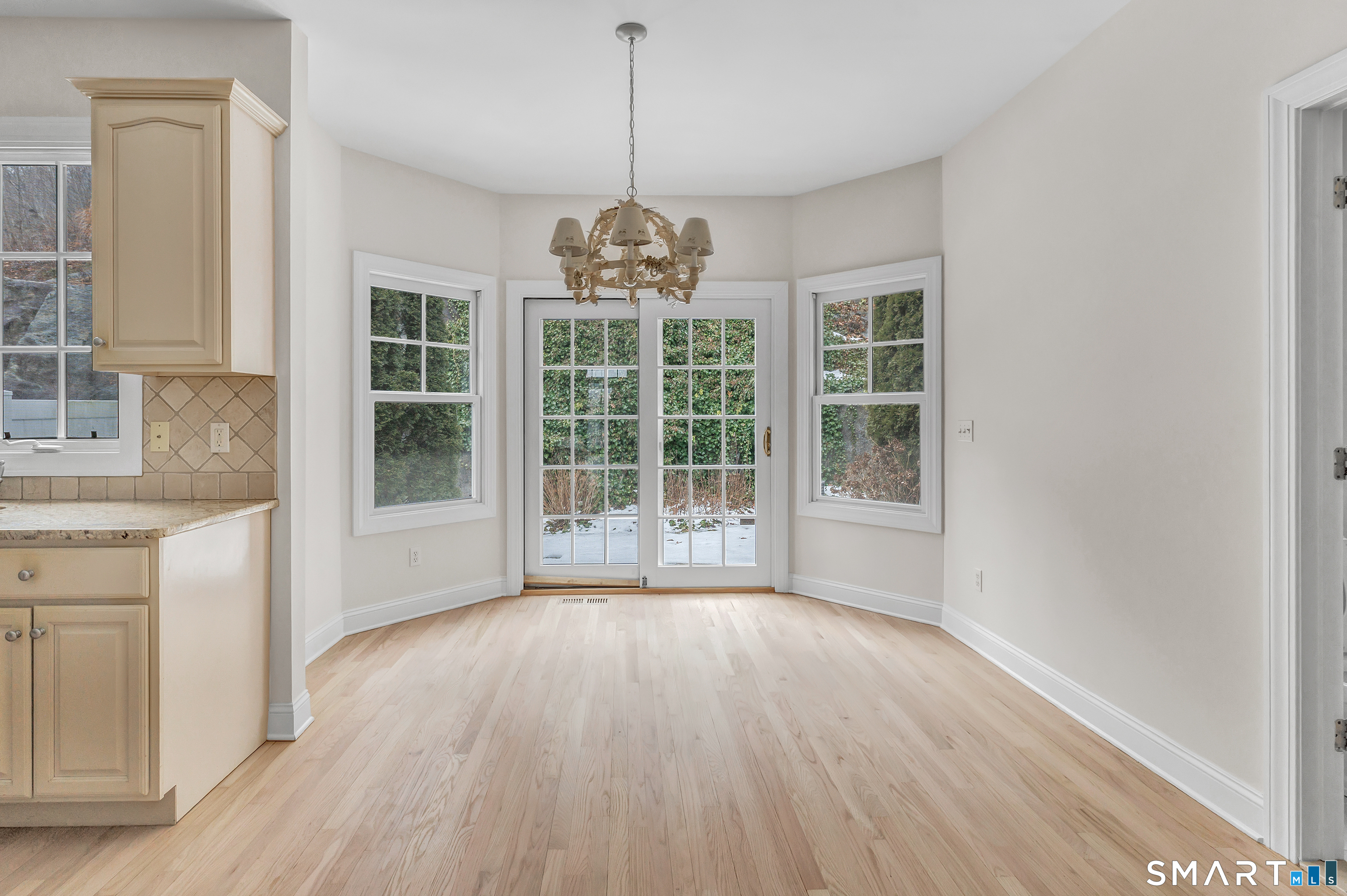 665 River Road, Unit 2 Shelton, CT 06484 - Photo 10 of 33 a view of wooden floor and windows in a room
