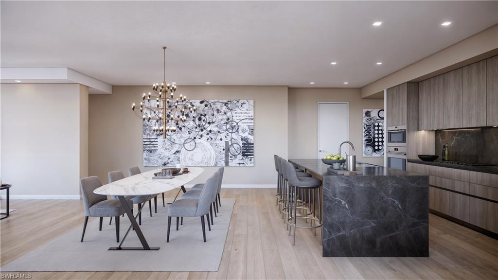 1301 3rd Avenue South Naples, FL 34102 - Photo 9 of 23 a view of a dining room with furniture window and wooden floor