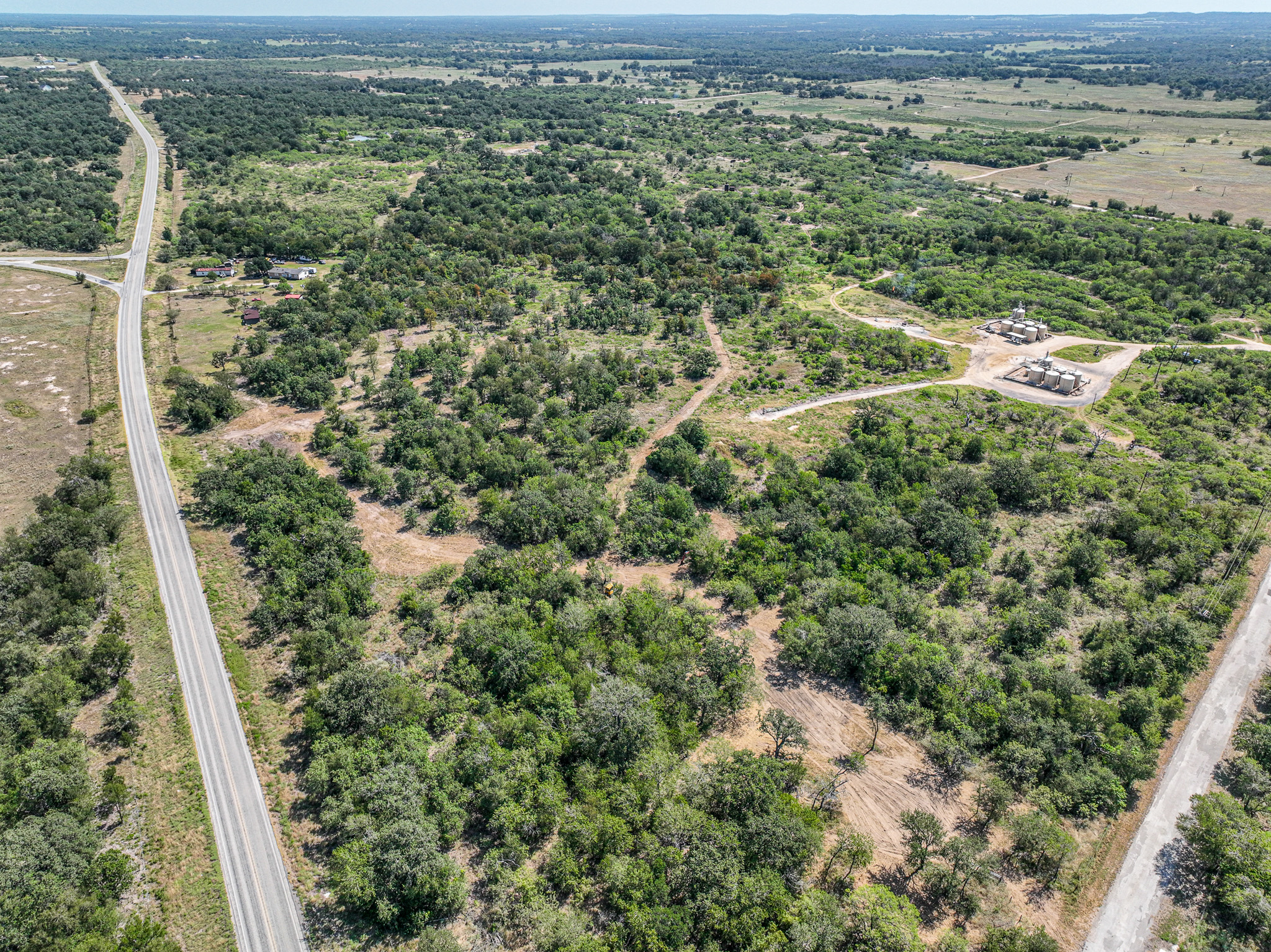 Vast stretches of native trees and rolling terrain offer endless possibilities on this rural property.
