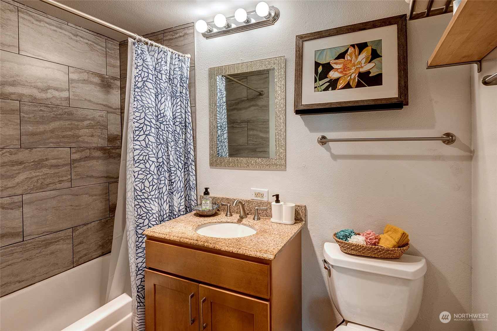 3028 Western Avenue, Unit 408 Seattle, WA 98121 - Photo 21 of 40 a bathroom with a sink mirror vanity and toilet