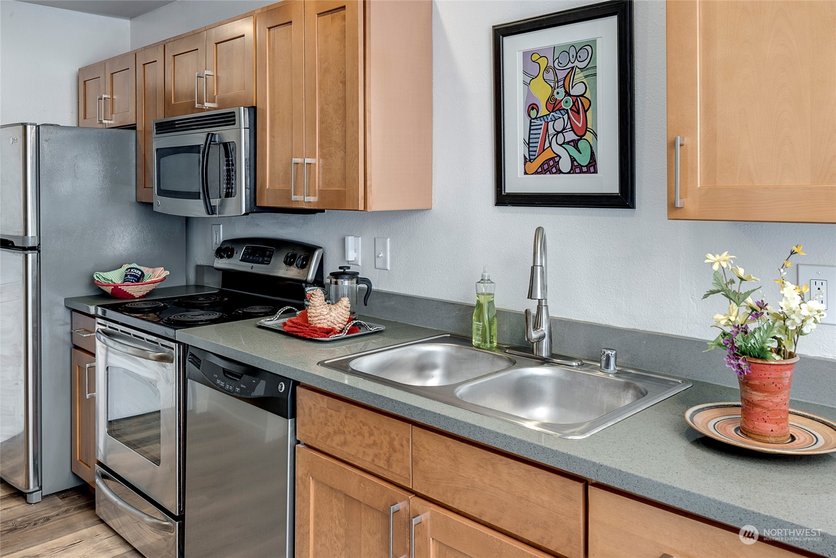 3028 Western Avenue, Unit 408 Seattle, WA 98121 - Photo 24 of 40 a kitchen with stainless steel appliances granite countertop a sink a stove microwave and refrigerator