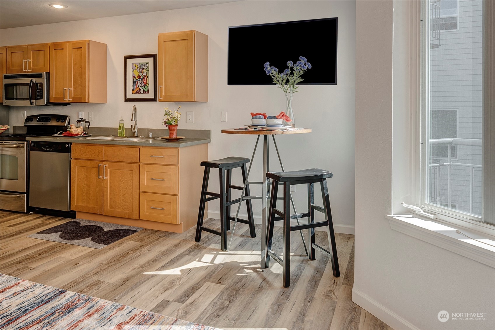 3028 Western Avenue, Unit 408 Seattle, WA 98121 - Photo 28 of 40 a workspace with wooden floor and a flat screen tv