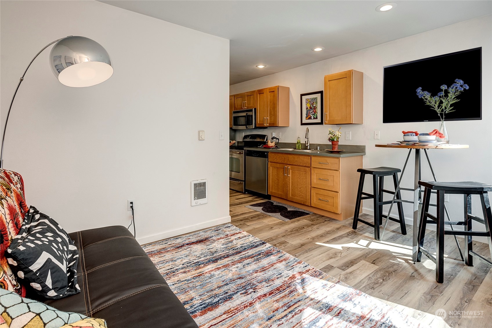 3028 Western Avenue, Unit 408 Seattle, WA 98121 - Photo 29 of 40 a living room with granite countertop furniture and a flat screen tv