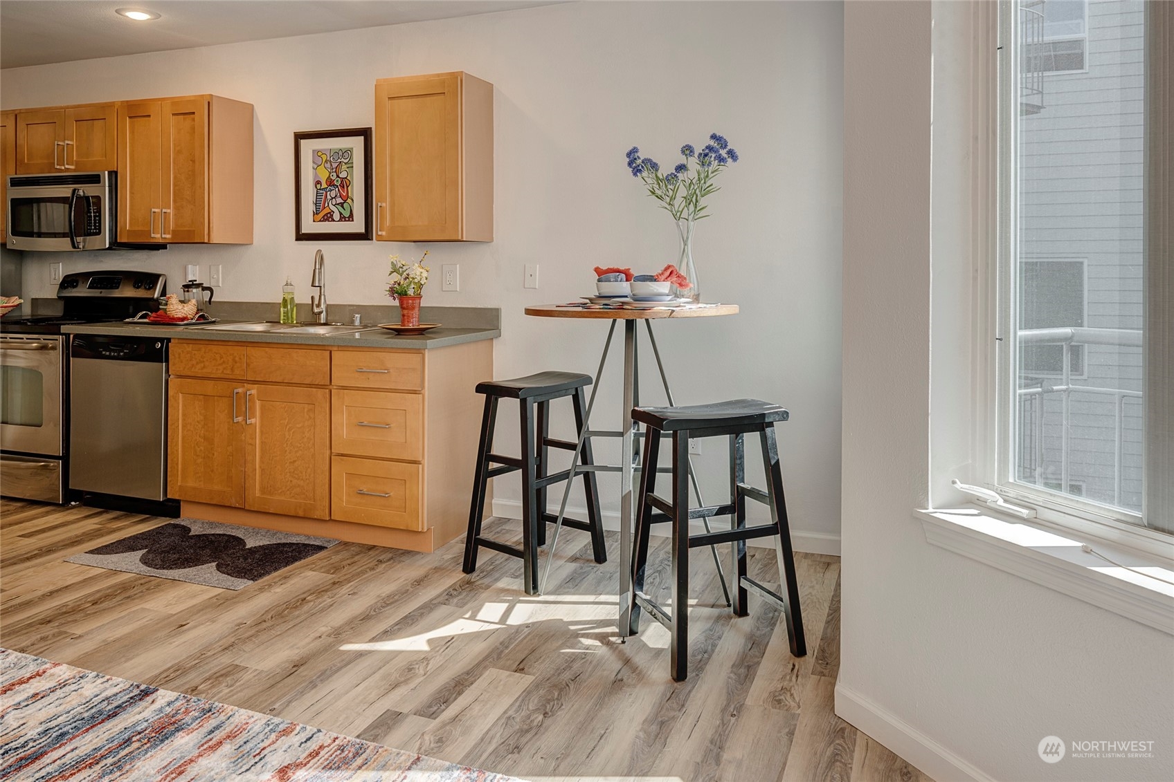 3028 Western Avenue, Unit 408 Seattle, WA 98121 - Photo 33 of 40 a workspace with furniture wooden floor and a window