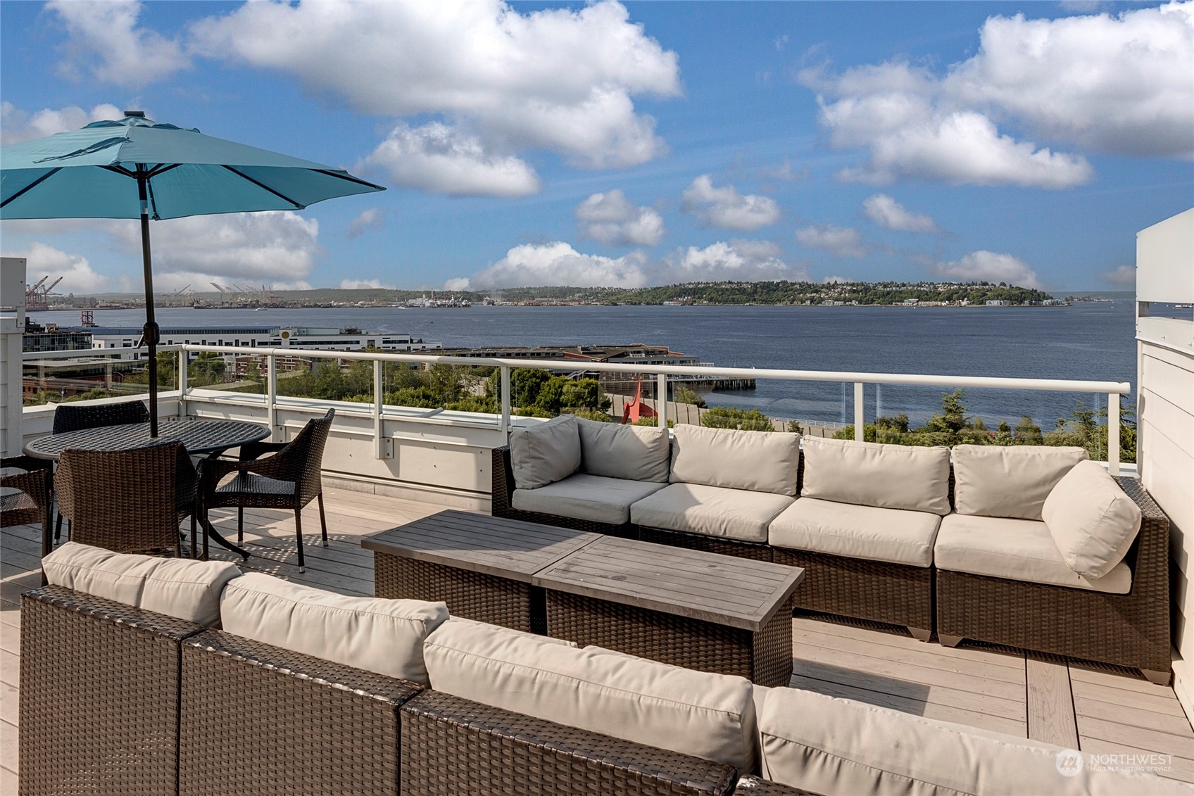 3028 Western Avenue, Unit 408 Seattle, WA 98121 - Photo 9 of 40 a roof deck with a table and chairs