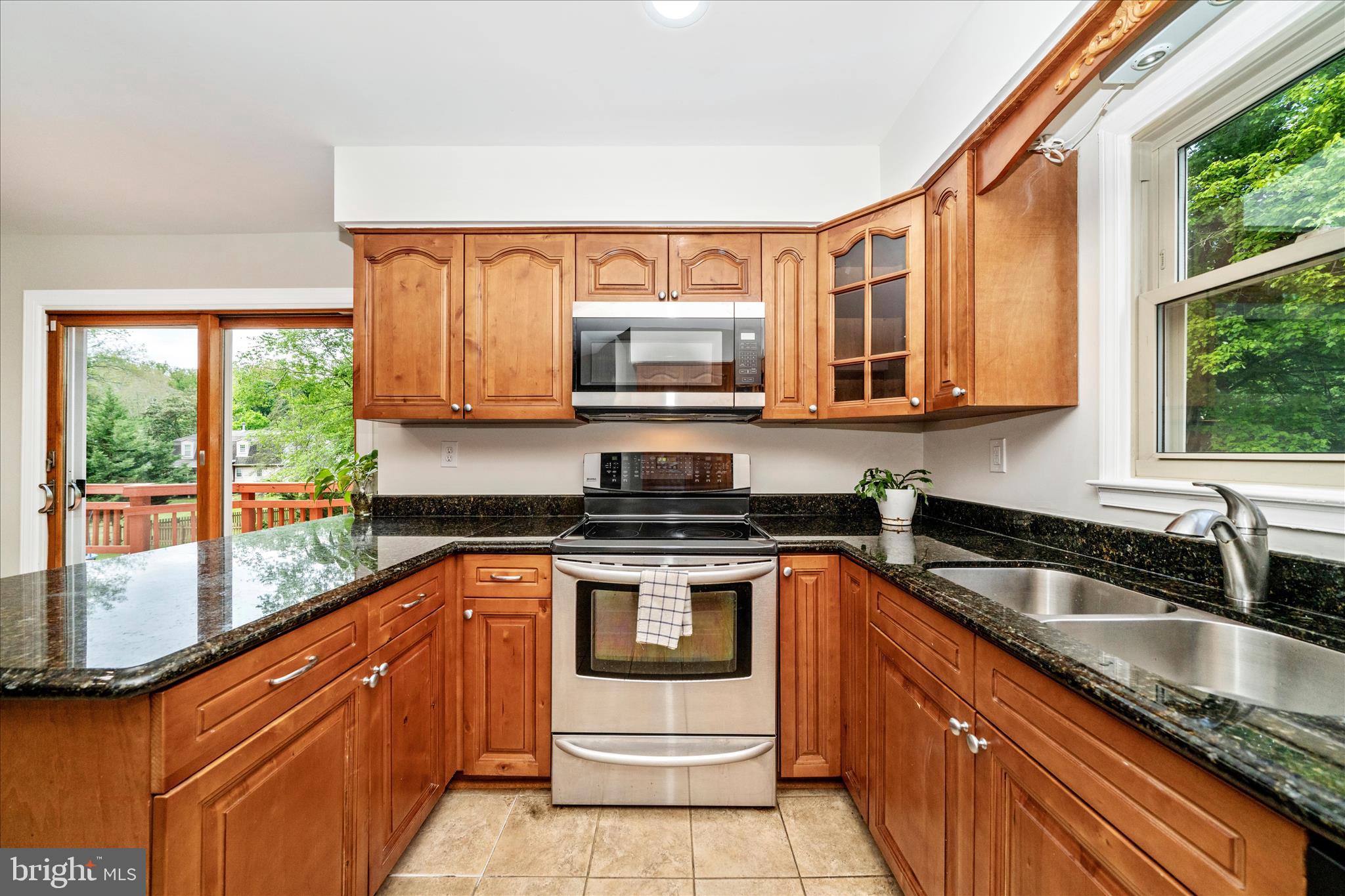 16000 Narrows Terrace Silver Spring, MD 20906 - Photo 16 of 54 a kitchen with stainless steel appliances granite countertop a sink stove and microwave