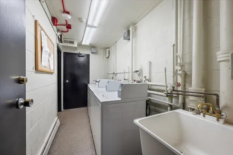 a room with a sink and a washer dryer