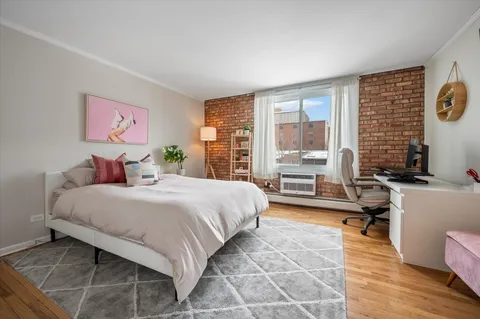 a bedroom with a bed and a large window