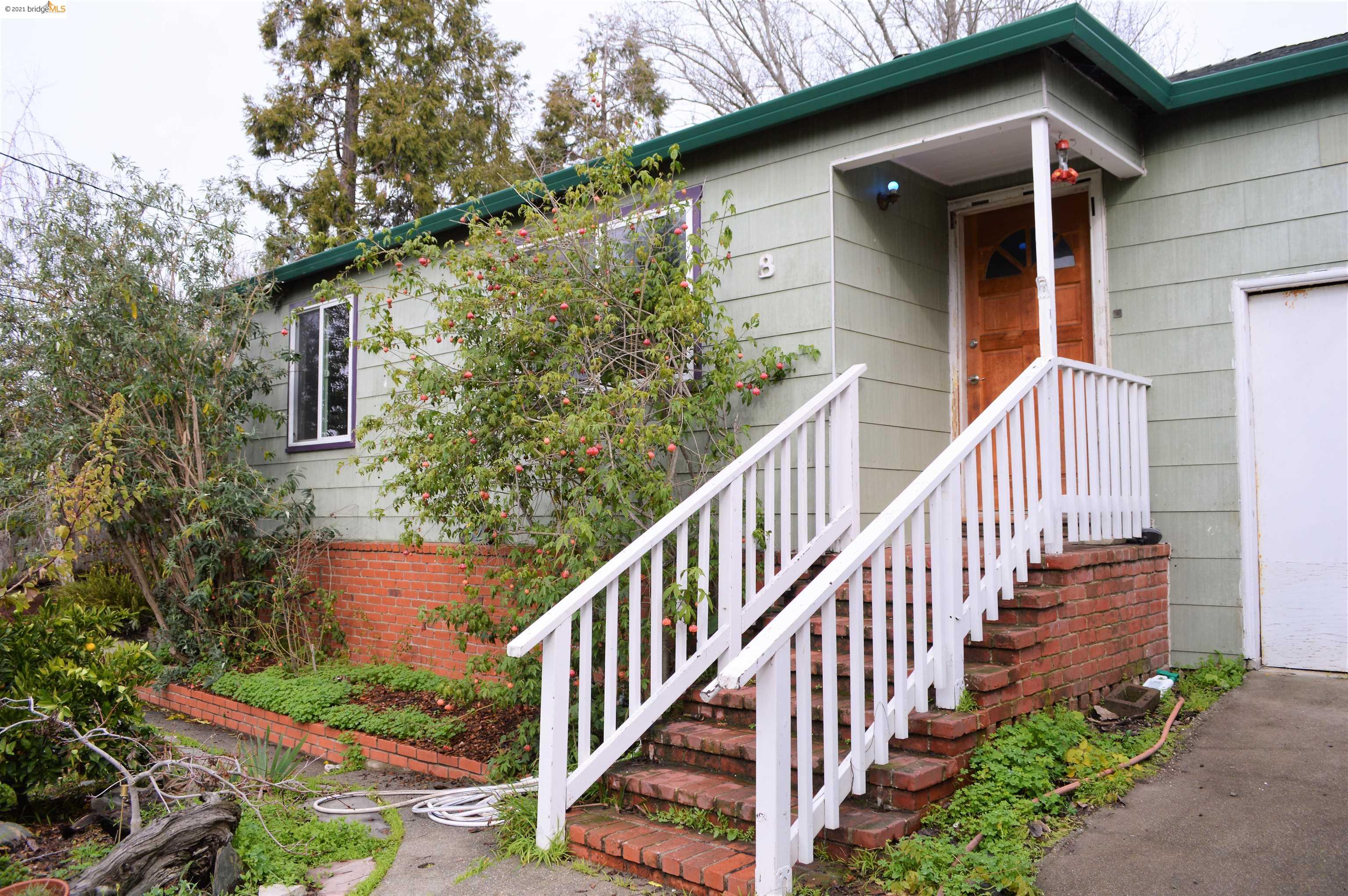 824 Kelvin Road El Sobrante, CA 94803 - Photo 1 of 1 a view of a house with wooden fence and potted plants