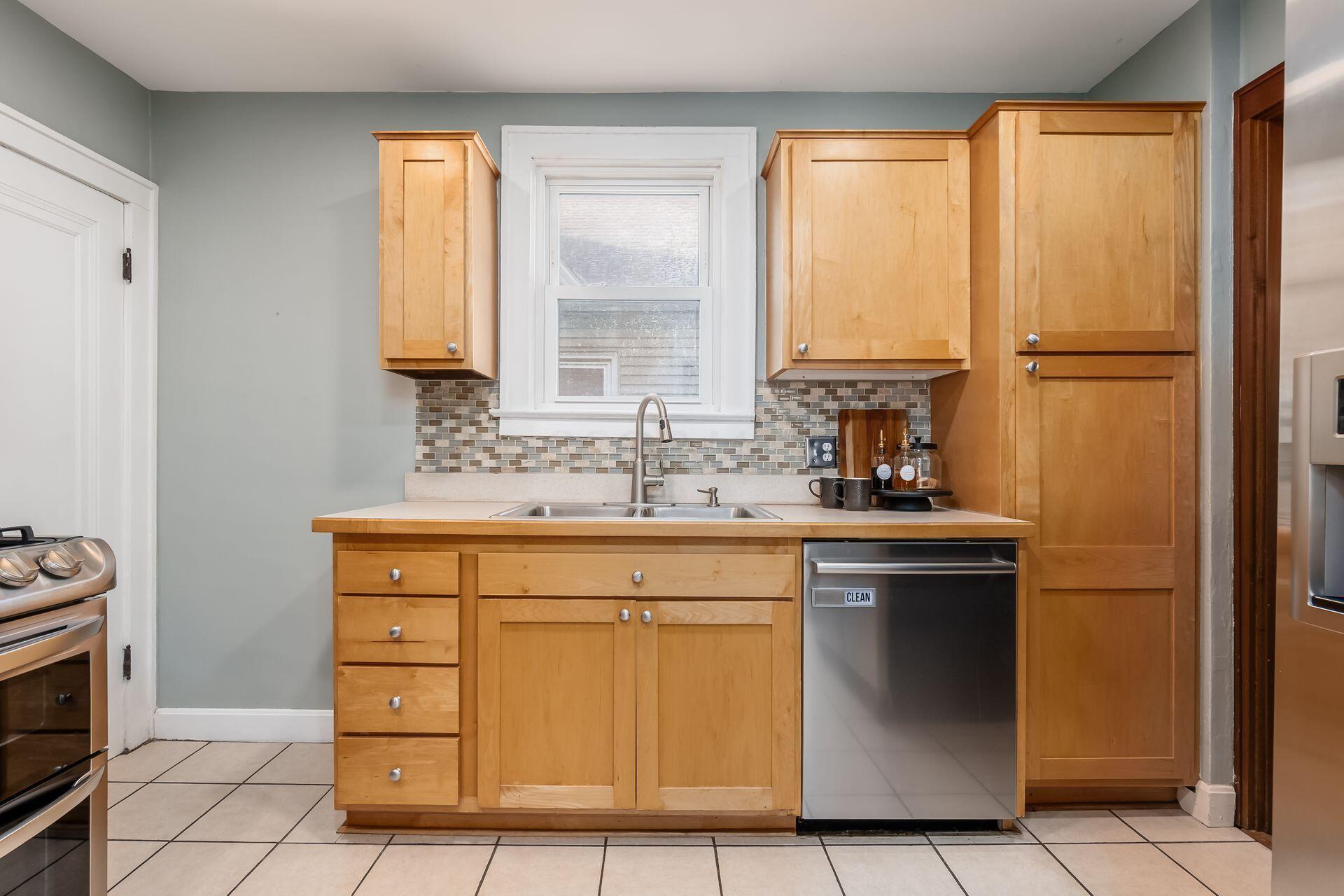 458 Crestview Road Columbus, OH 43202 - Photo 21 of 41 Open kitchen with maple cabinets, tile backsplash and stainless steel appliances.