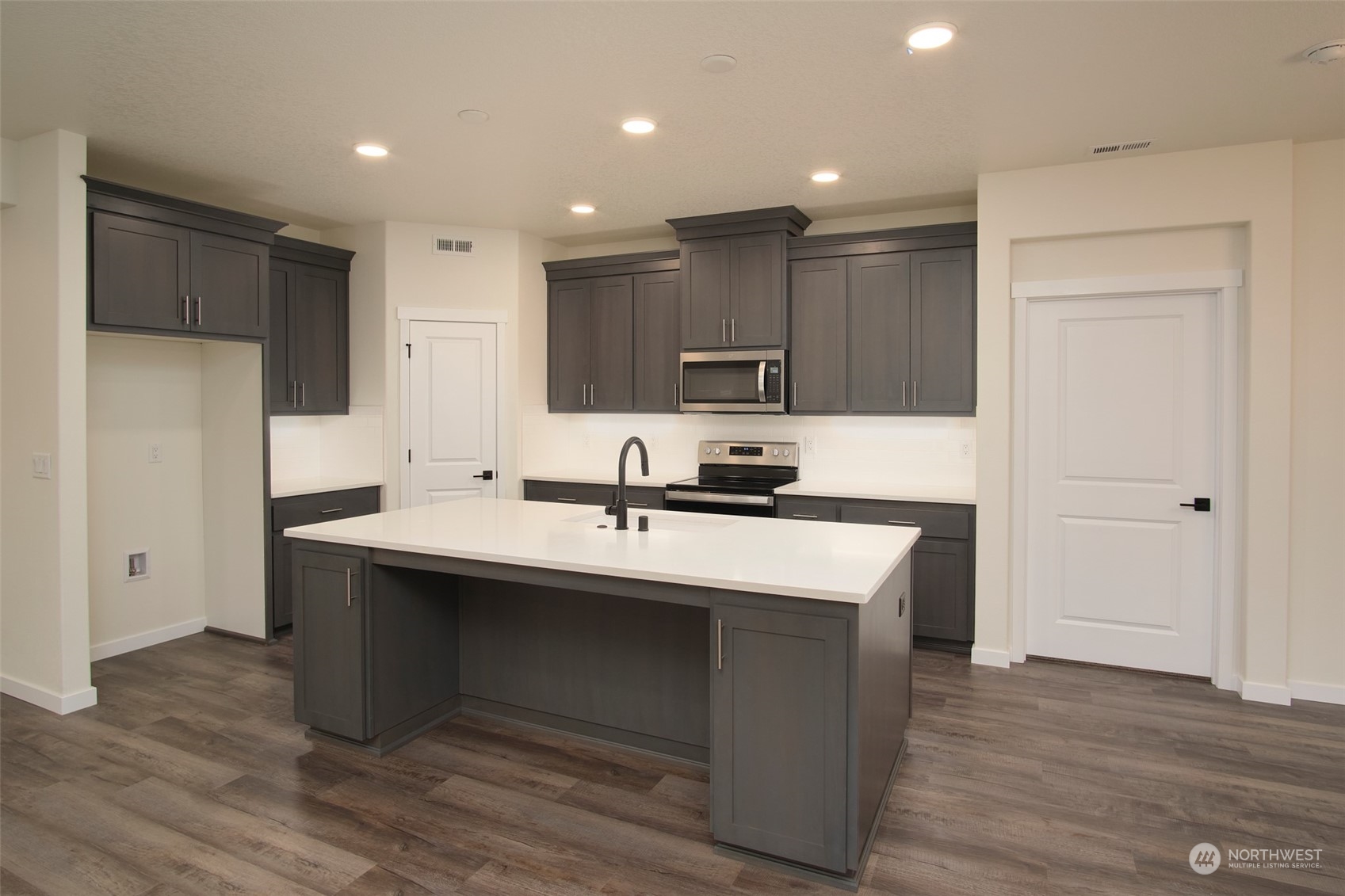 1070 Rw Fletcher Street Winlock, WA 98596 - Photo 3 of 21 a kitchen with kitchen island a sink stainless steel appliances and cabinets