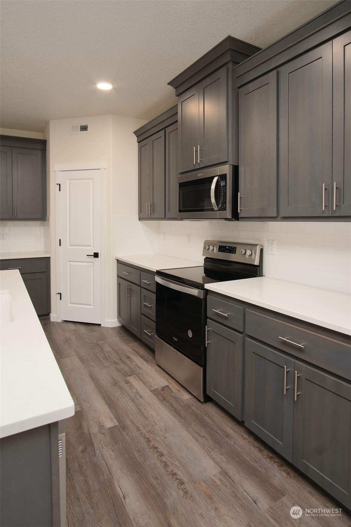 1070 Rw Fletcher Street Winlock, WA 98596 - Photo 4 of 21 a kitchen with stainless steel appliances granite countertop a sink stove and cabinets