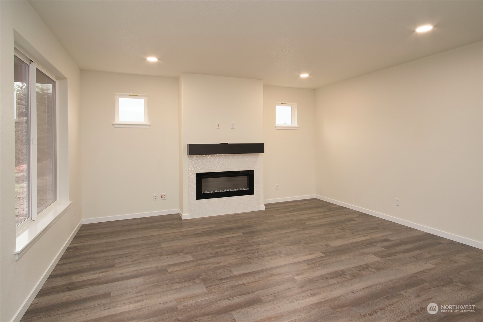 1070 Rw Fletcher Street Winlock, WA 98596 - Photo 6 of 21 a view of empty room with wooden floor and fireplace