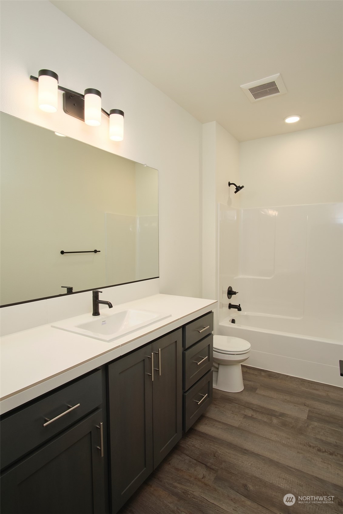 1070 Rw Fletcher Street Winlock, WA 98596 - Photo 10 of 21 a bathroom with a granite countertop sink a toilet and bathtub
