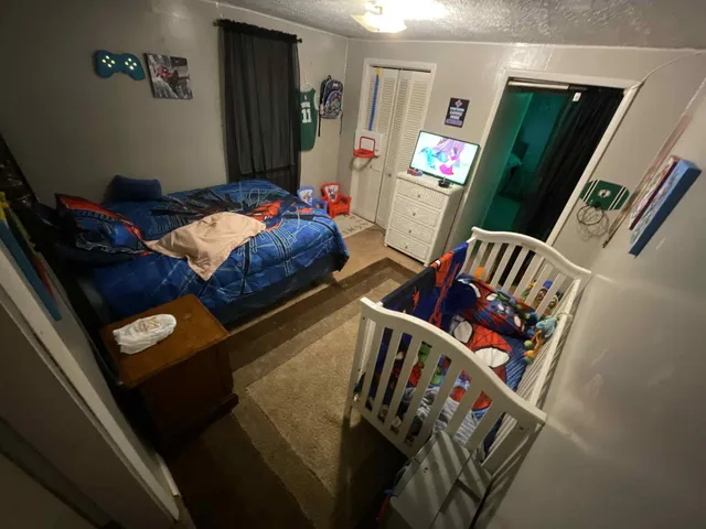 a bedroom with two beds and a painting on the wall