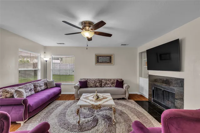 a living room with furniture fireplace and flat screen tv