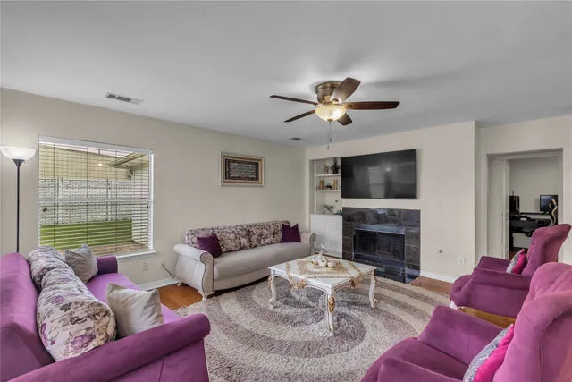 a living room with furniture a flat screen tv and a large window
