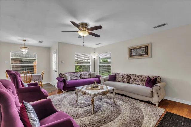 a living room with furniture ceiling fan and a rug