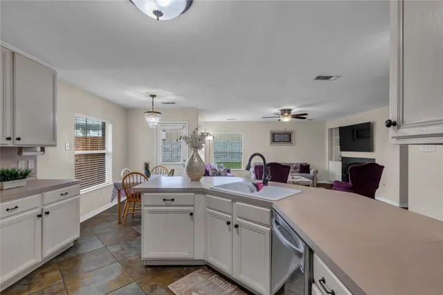 a kitchen with a sink a stove and cabinets