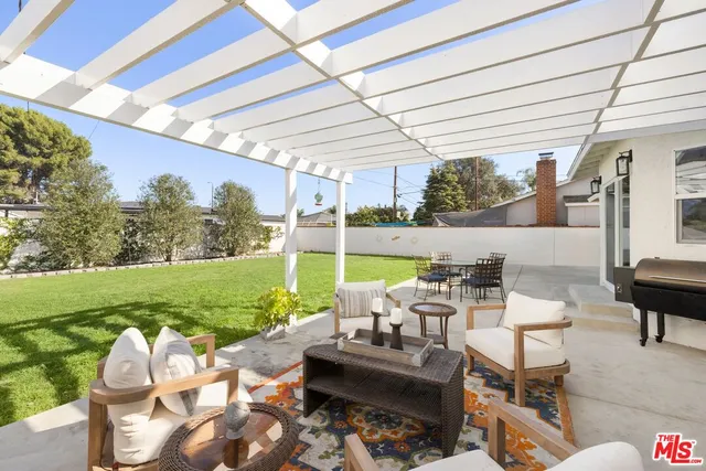 a building outdoor space with patio furniture and garden