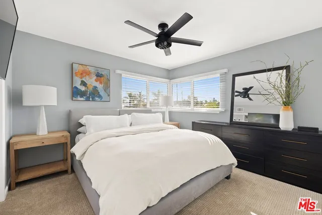 a bedroom with a bed and a dresser