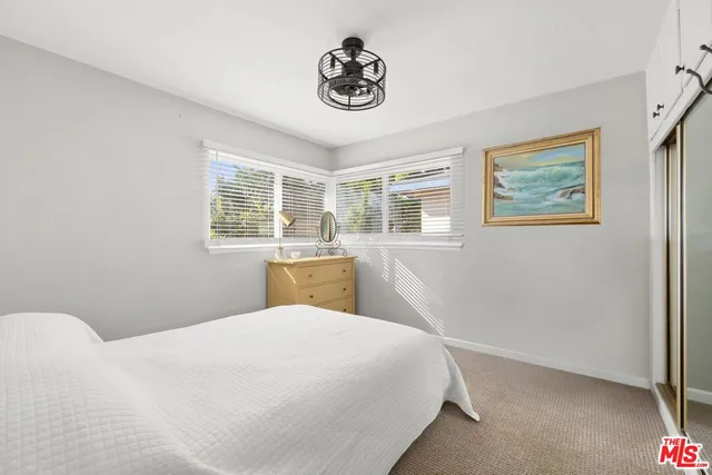 a bed room with a bed and a window