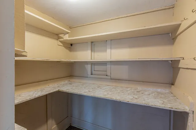 a view of storage and utility room with wooden floor