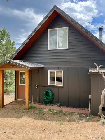 a backyard of a house with potted plants