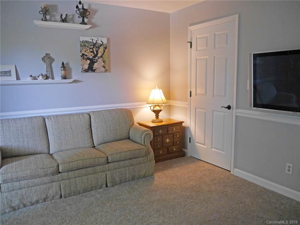 17925 Kings Point Drive, Unit F Cornelius, NC 28031 - Photo 11 of 36 a living room with furniture and a flat screen tv