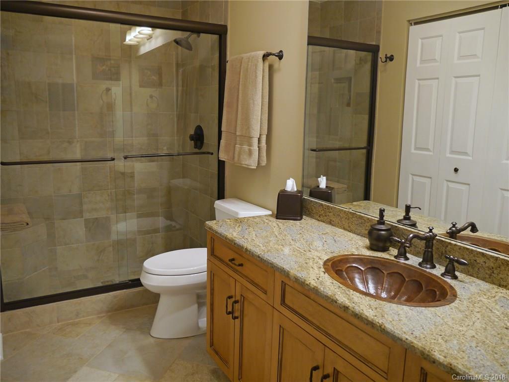 17925 Kings Point Drive, Unit F Cornelius, NC 28031 - Photo 12 of 36 a bathroom with a sink and a mirror