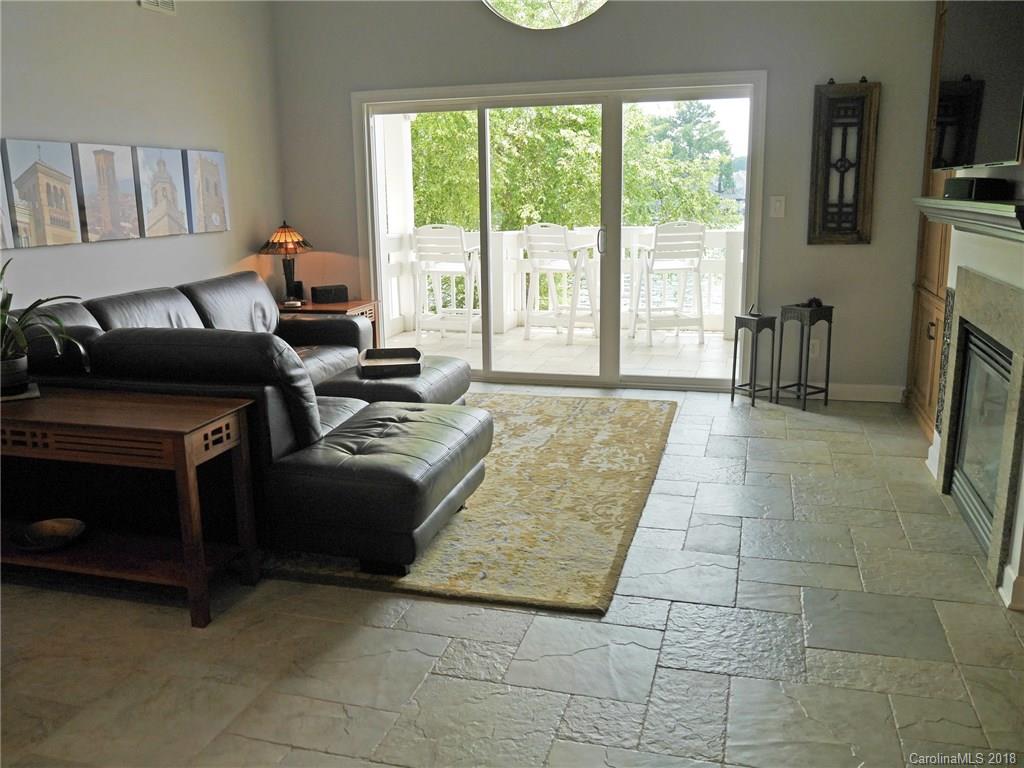 17925 Kings Point Drive, Unit F Cornelius, NC 28031 - Photo 13 of 36 a living room with furniture and a fireplace