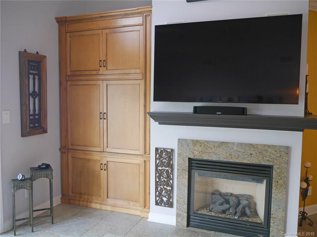 17925 Kings Point Drive, Unit F Cornelius, NC 28031 - Photo 15 of 36 a living room with a fireplace and a flat screen tv