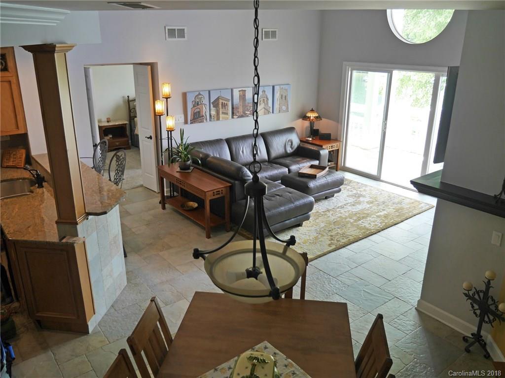 17925 Kings Point Drive, Unit F Cornelius, NC 28031 - Photo 16 of 36 a living room with furniture a window and a flat screen tv