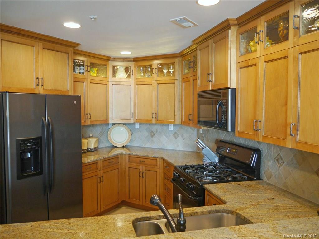 17925 Kings Point Drive, Unit F Cornelius, NC 28031 - Photo 19 of 36 a kitchen with stainless steel appliances granite countertop a refrigerator and a stove