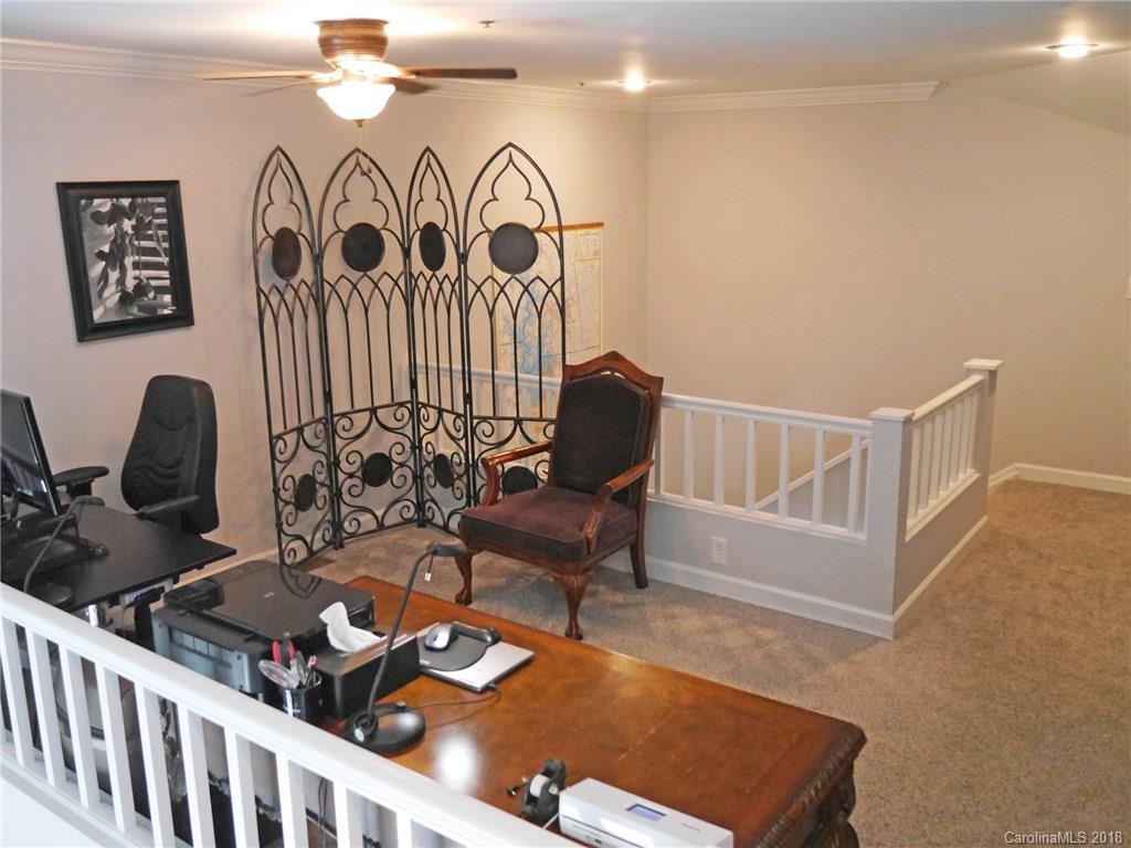 17925 Kings Point Drive, Unit F Cornelius, NC 28031 - Photo 20 of 36 a living room with furniture and a window