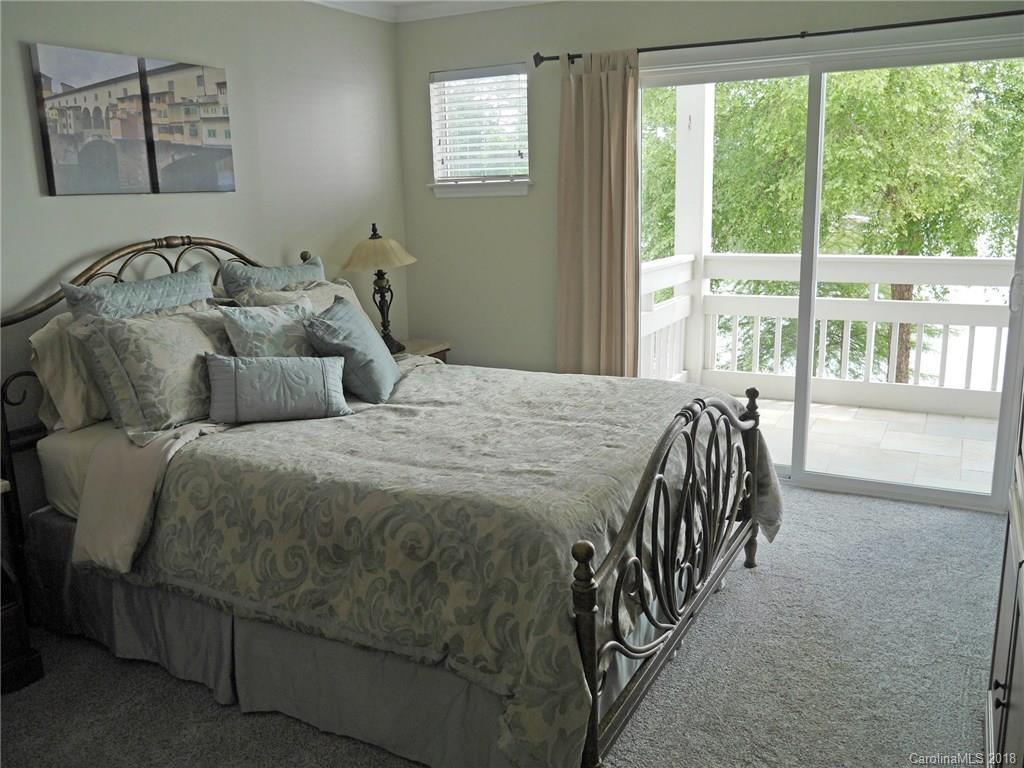 17925 Kings Point Drive, Unit F Cornelius, NC 28031 - Photo 3 of 36 a bedroom with a bed and a table