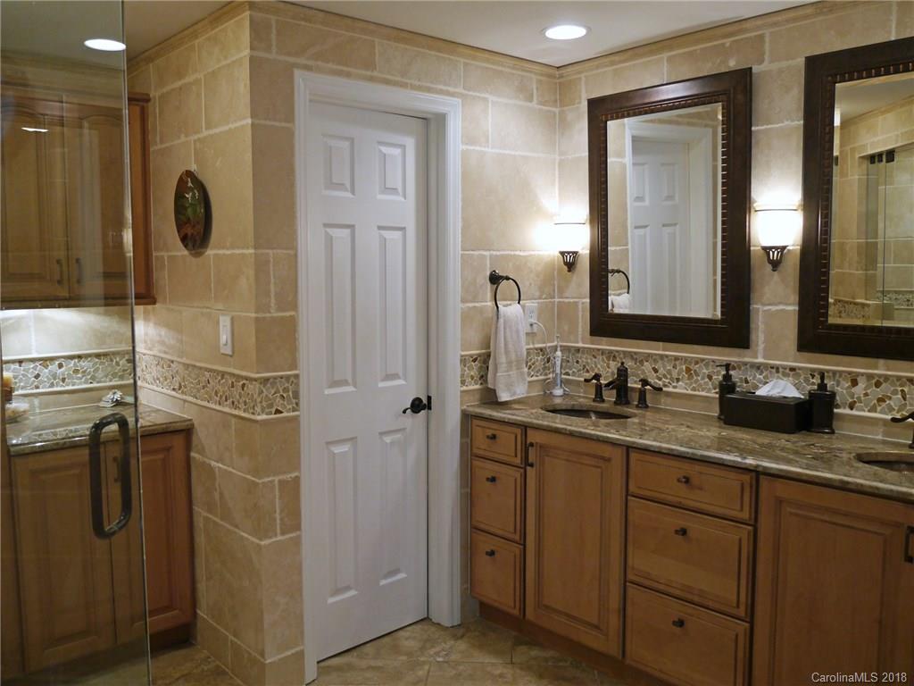 17925 Kings Point Drive, Unit F Cornelius, NC 28031 - Photo 7 of 36 a bathroom with a granite countertop sink a mirror and shower