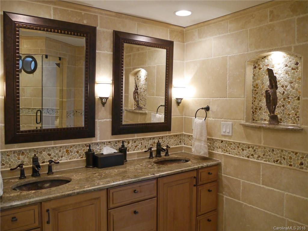 17925 Kings Point Drive, Unit F Cornelius, NC 28031 - Photo 8 of 36 a bathroom with a double vanity sink and a mirror